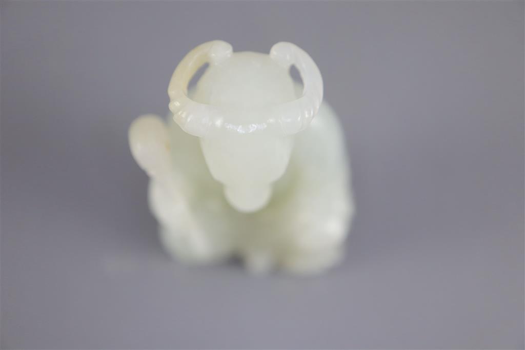 A Chinese pale celadon jade seated figure of a ram-headed immortal, 4.9cm high